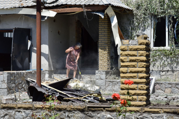 verkhnya-tersa-ukraine-13th-july-2023-a-woman-cleans-an-area-of-a-private-house-damaged-by-russian-shelling-in-the-village-verkhnya-tersa-on-the-505th-day-of-the-full-scale-russian-war-against-uk
