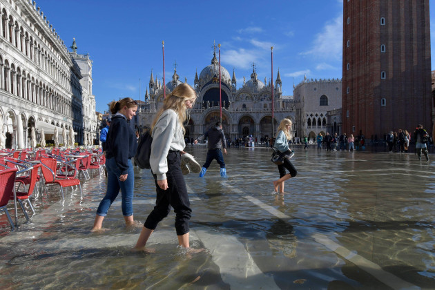 people-walk-in-a-flooded-st-marks-square-in-venice-italy-friday-nov-5-2021-after-venice-suffered-the-second-worst-flood-in-its-history-in-november-2019-it-was-inundated-with-four-more-excepti
