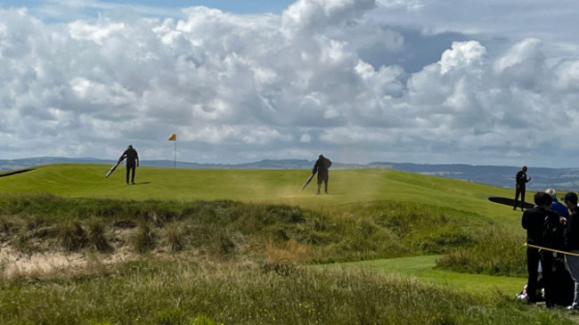 ground-staff-blow-away-orange-paint-on-the-grass-following-a-protest-by-just-stop-oil-on-the-17th-green-during-day-two-of-the-open-at-royal-liverpool-wirral-picture-date-friday-july-21-2023