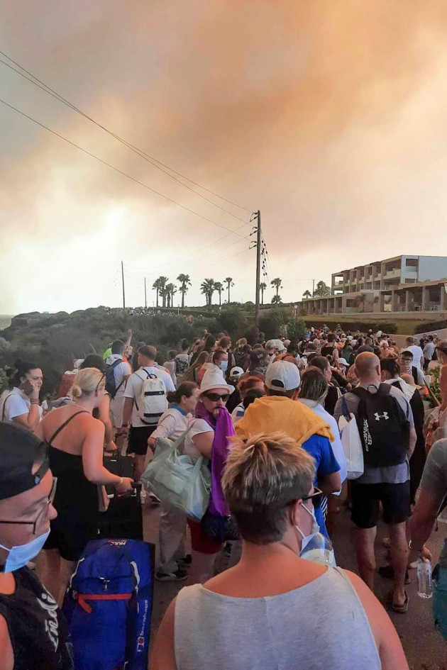 tourists-are-being-evacuated-during-a-forest-fire-on-the-island-of-rhodes-greece-saturday-july-22-2023-a-large-blaze-burning-on-the-greek-island-of-rhodes-for-the-fifth-day-has-forced-authorities