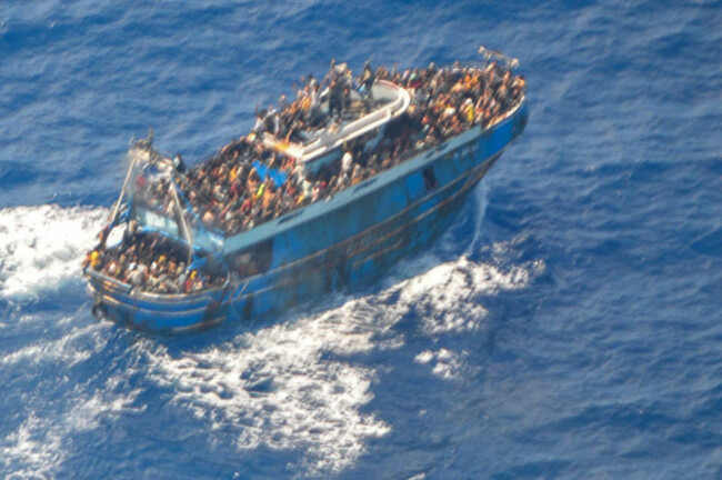this-undated-handout-image-provided-by-greeces-coast-guard-on-wednesday-june14-2023-shows-scores-of-people-on-a-battered-fishing-boat-that-later-capsized-and-sank-off-southern-greece-a-fishing-bo