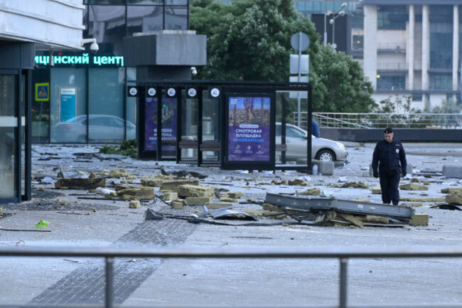 an-investigator-examines-an-area-next-to-the-damaged-skyscraper-in-the-moscow-city-business-district-after-a-reported-drone-attack-in-moscow-russia-early-sunday-july-30-2023-ap-photo