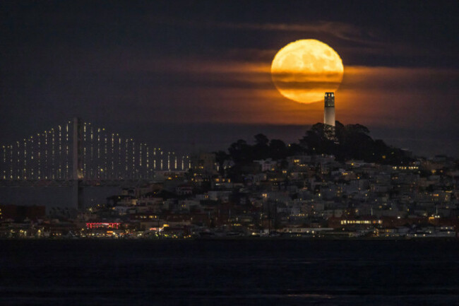 a-supermoon-also-known-as-the-sturgeon-moon-rises-with-san-franciscos-coit-tower-in-the-foreground-seen-from-from-sausalito-calif-thursday-aug-11-2022-carlos-avila-gonzalezsan-francisco-c