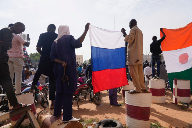 nigeriens-holding-a-russian-flag-participate-in-a-march-called-by-supporters-of-coup-leader-gen-abdourahmane-tchiani-in-niamey-niger-sunday-july-30-2023-days-after-after-mutinous-soldiers-ousted
