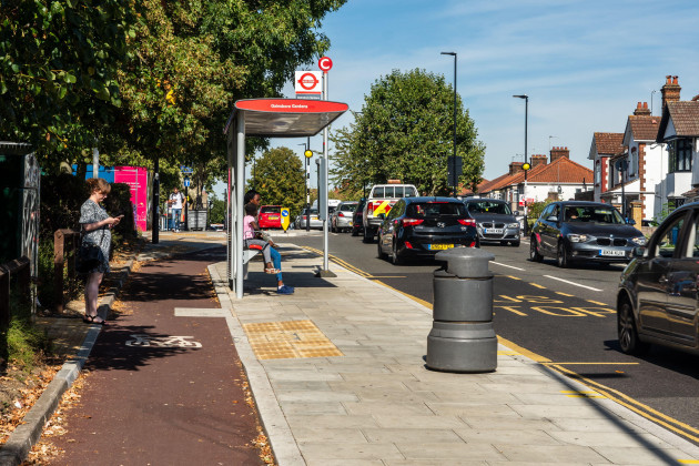 passengers-wait-at-a-floating-bus-stop-on-the-route-of-a-newly-built-protected-cycle-track-in-harrow-london