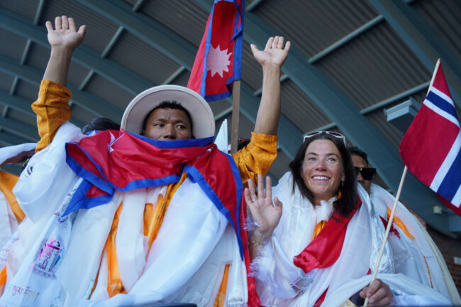 kathmandu-ne-nepal-5th-aug-2023-climbers-tenjen-sherpa-l-and-kristin-harila-r-gesture-towards-the-media-after-they-arrive-at-the-tribhuvan-international-airport-in-kathmandu-nepal-on-august