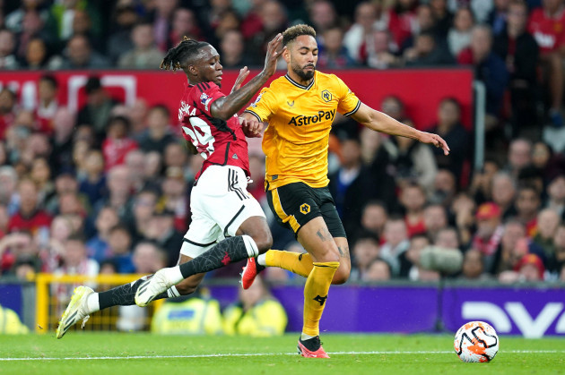 manchester-uniteds-aaron-wan-bissaka-left-and-wolverhampton-wanderers-matheus-cunha-battle-for-the-ball-during-the-premier-league-match-at-old-trafford-manchester-picture-date-monday-august-14