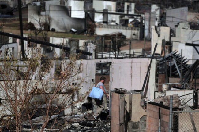 a-photo-shows-the-wildfire-ravaged-town-of-lahaina-on-the-island-of-maui-in-state-of-hawaii-united-states-on-august-19-2023-a-man-walks-in-dumb-surprise-the-yomiuri-shimbun-via-ap-images