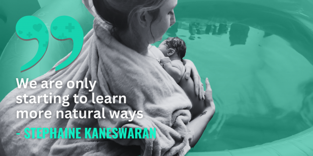 Stephanie Kaneswaran wrapped in a blanket while sitting in a birthing pool full of water holding her newborn baby above the water, with quote - We are only starting to learn more natural ways.