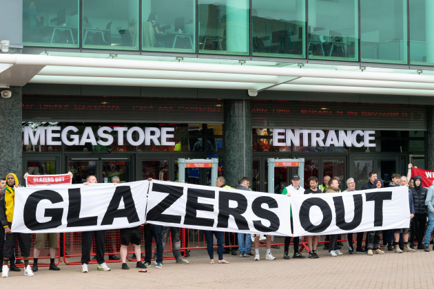 protesters-outside-manchester-united-football-ground-megastore-force-closure-on-day-the-club-unveil-their-new-home-shirt-banner-text-glazers-out