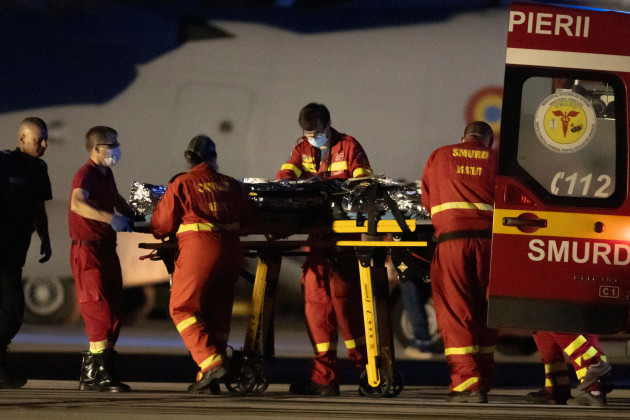 a-firefighter-that-was-injured-in-the-blaze-outside-the-romanian-capital-bucharest-is-moved-abroad-a-military-transport-plane-en-route-to-a-hospital-in-brussels-at-the-baza-90-air-force-base-in-otope