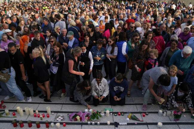 people-light-candles-at-the-end-of-the-vigil-in-kickham-plaza-co-tipperary-in-memory-of-luke-mcsweeney-24-his-18-year-old-sister-grace-mcsweeney-zoey-coffey-and-nicole-murphy-both-also-18-who-d