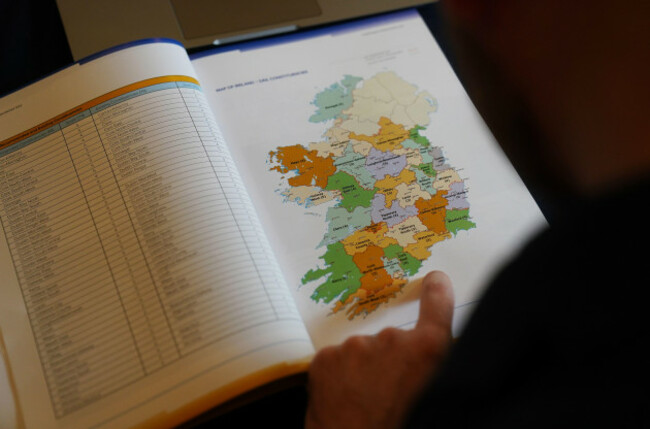 a-journalist-looks-at-a-map-of-ireland-during-a-press-confrence-at-the-royal-college-of-physicians-dublin-for-the-electoral-commission-announcement-of-the-much-anticipated-new-constituency-boundarie