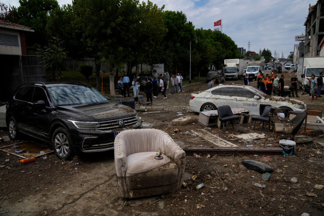 people-walk-next-to-scattered-vehicles-and-furniture-on-the-aftermath-of-floods-caused-by-heavy-rains-in-istanbul-turkey-wednesday-sept-6-2023-severe-rainstorms-that-lashed-parts-of-greece-turk