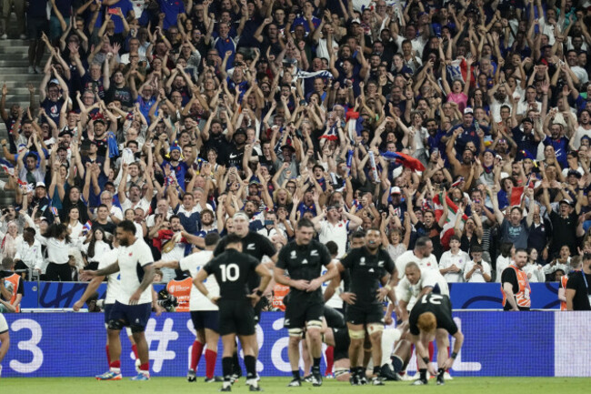 france-fans-celebrate-winning-as-new-zealand-players-look-on-dejected