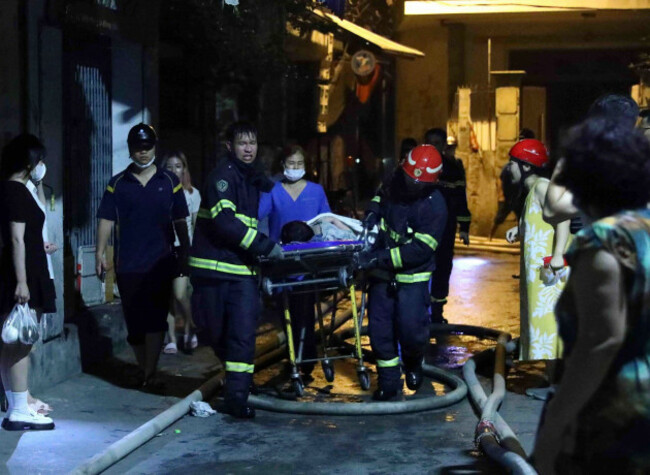 rescue-workers-carry-a-person-on-stretcher-out-of-a-building-on-fire-in-hanoi-vietnam-wednesday-sept-13-2023-authorities-said-many-people-had-been-killed-after-a-fire-broke-out-in-the-apartment