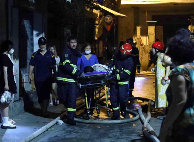 rescue-workers-carry-a-person-on-stretcher-out-of-a-building-on-fire-in-hanoi-vietnam-wednesday-sept-13-2023-authorities-said-many-people-had-been-killed-after-a-fire-broke-out-in-the-apartment