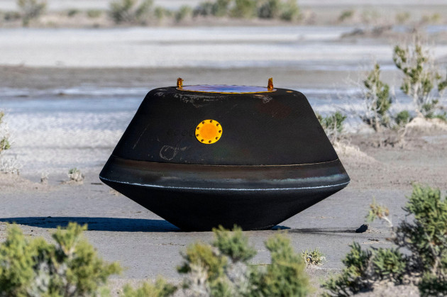 in-this-photo-provided-by-nasa-the-sample-return-capsule-from-nasas-osiris-rex-mission-lies-on-the-ground-shortly-after-touching-down-in-the-desert-at-the-department-of-defenses-utah-test-and-trai