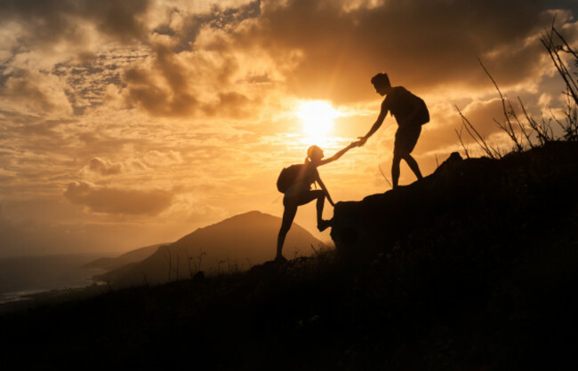peoplehelpingeachotherconcept-manhelpingwomanupthe