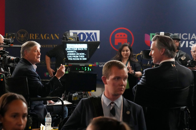 commentator-sean-hannity-left-talks-to-california-gov-gavin-newsom-in-the-spin-room-after-a-republican-presidential-primary-debate-hosted-by-fox-business-network-and-univision-wednesday-sept-27