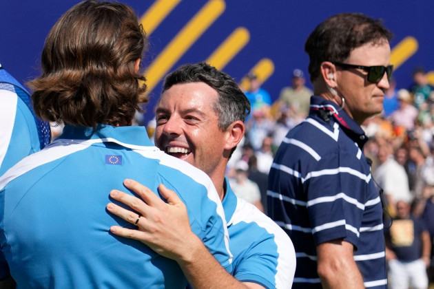 europes-rory-mcilroy-center-celebrates-with-playing-partner-europes-tommy-fleetwood-after-they-won-their-morning-foursome-match-21-in-the-background-is-united-states-team-captain-zach-johnson