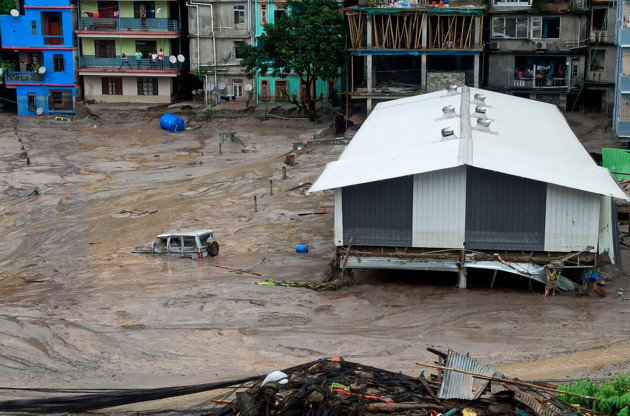 a-vehicle-is-seen-partially-submerged-in-water-after-flash-floods-triggered-by-a-sudden-heavy-rainfall-swamped-the-rangpo-town-in-sikkim-india-thursday-oct-5-2023-the-flooding-took-place-along-th