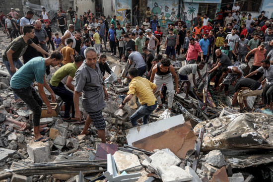 khan-yunis-palestinian-territories-09th-oct-2023-palestinians-search-the-rubble-of-a-destroyed-house-following-an-israeli-airstrike-on-khan-yunis-in-the-southern-gaza-strip-israel-pounded-the-ga