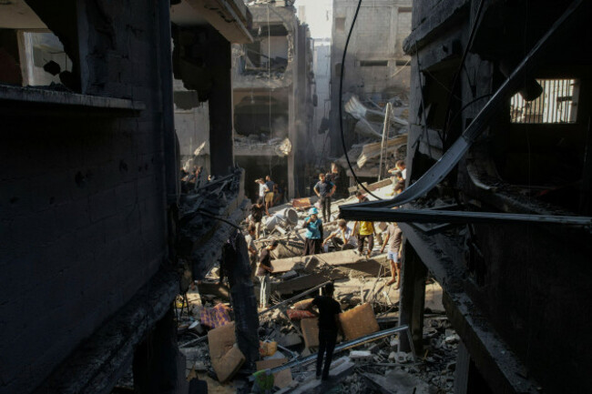 palestinians-inspect-the-rubble-of-buildings-hit-by-an-israeli-airstrike-at-al-shati-refugee-camp-thursday-oct-12-2023-israels-retaliation-has-escalated-after-gazas-militant-hamas-rulers-launche