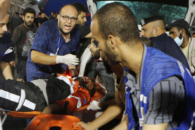 a-palestinian-civil-defense-officer-is-carried-into-the-shifa-hospital-after-israeli-airstrikes-targeted-a-civil-defense-site-in-gaza-city-central-gaza-strip-early-monday-oct-16-2023-ap-photo