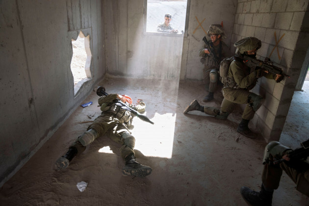 an-israeli-soldier-pretending-to-be-dead-palestinian-militant-lies-on-the-ground-during-a-training-session-simulating-urban-warfare-at-the-zeelim-army-base-southern-israel-jan-4-2022-officially