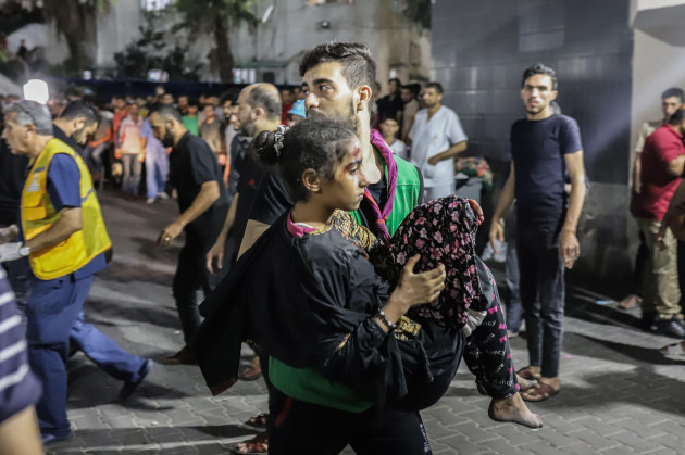 gaza-city-palestinian-territories-17th-oct-2023-a-palestinian-man-carries-a-girl-injured-in-an-israeli-shelling-on-the-ahli-arab-hospital-to-al-shifa-hospital-in-gaza-city-according-to-the-gaza