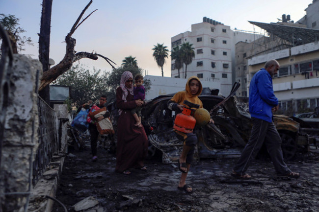 palestinians-carry-belongings-as-they-leave-al-ahli-hospital-which-they-were-using-as-a-shelter-in-gaza-city-wednesday-oct-18-2023-the-hamas-run-health-ministry-says-an-israeli-airstrike-caused