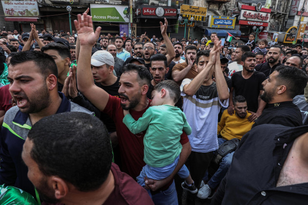 nablus-palestinian-territories-18th-oct-2023-palestinian-demonstrators-gesture-and-chant-slogans-during-a-demonstration-against-israel-in-the-west-bank-city-of-nablus-following-a-devastating-expl
