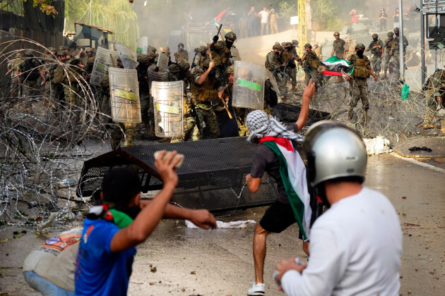 protesters-throw-stones-towards-lebanese-army-during-a-demonstration-in-solidarity-with-the-palestinian-people-in-gaza-near-the-u-s-embassy-in-aukar-a-northern-suburb-of-beirut-lebanon-wednesday