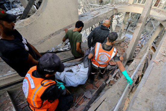 palestinians-carry-the-lifeless-body-of-a-man-found-inside-a-destroyed-house-following-israeli-airstrikes-on-gaza-city-thursday-oct-19-2023-ap-photoabed-khaled