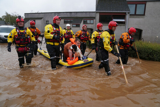 members-of-the-emergency-services-help-local-residents-to-safety-in-brechin-scotland-as-storm-babet-batters-the-country-flood-warnings-are-in-place-in-scotland-as-well-as-parts-of-northern-england