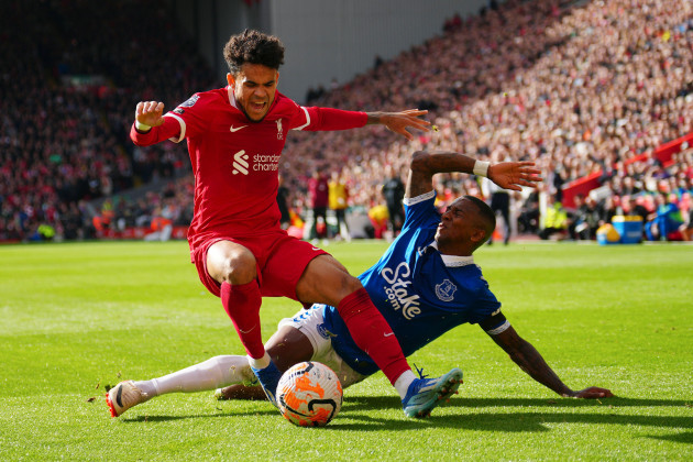liverpools-luis-diaz-left-challenges-for-the-ball-with-evertons-ashley-young-during-the-english-premier-league-soccer-match-between-liverpool-and-everton-at-anfield-in-liverpool-england-saturda