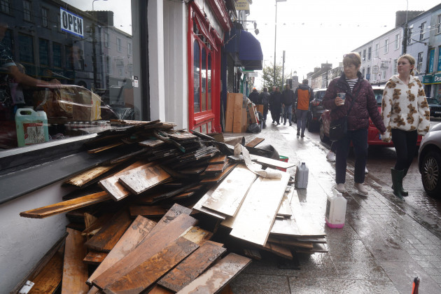 people-walk-past-damaged-shops-on-main-street-in-midleton-co-cork-after-storm-babet-the-second-named-storm-of-the-season-swept-in-picture-date-thursday-october-19-2023