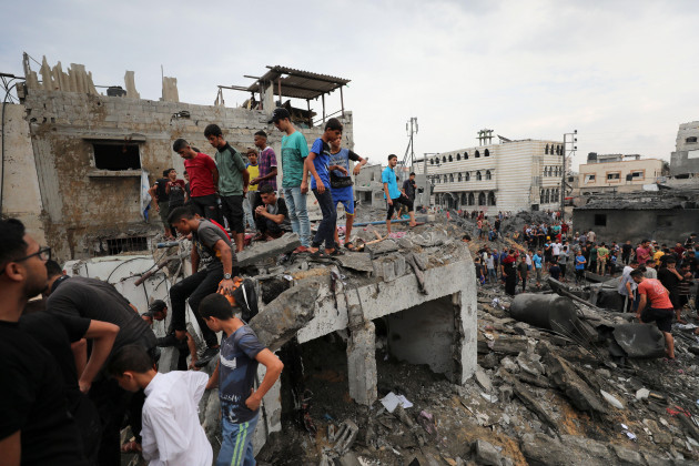 palestinians-inspect-the-rubble-of-a-destroyed-building-after-an-israeli-airstrike-in-deir-al-balah-gaza-strip-friday-oct-27-2023-ap-photoali-mahmoud