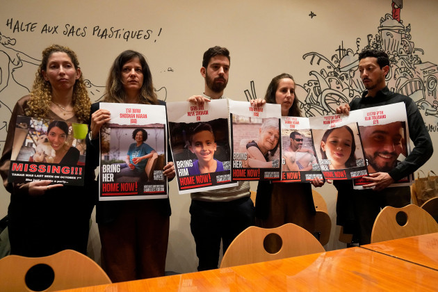 from-the-left-adva-gutman-ayelet-sela-bin-nun-alon-adar-adva-adar-and-daniel-toledano-hold-portraits-of-relatives-held-hostages-by-the-hamas-militants-during-a-press-conference-at-the-paris-town