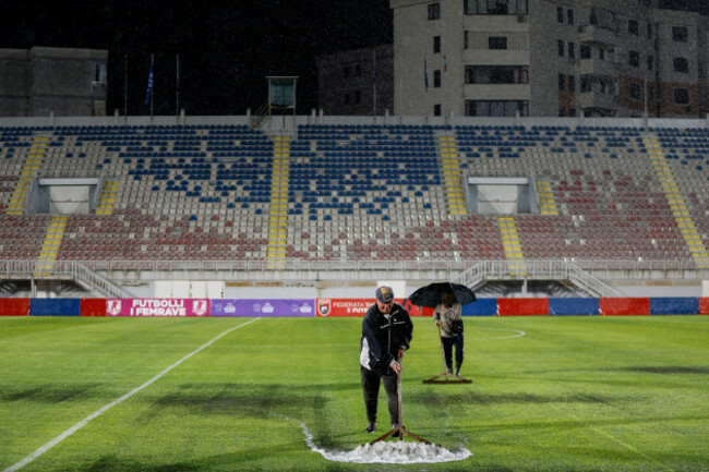 staff-work-to-clear-water-from-the-pitch-after-play-was-suspended