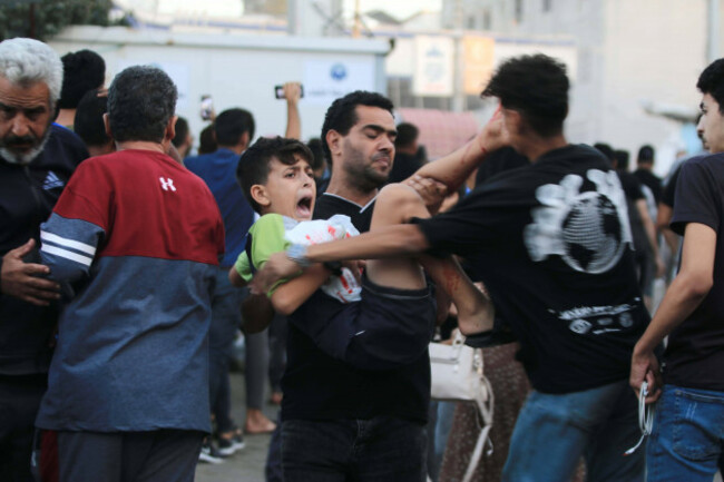 people-help-injured-ones-following-the-israeli-attacks-on-the-entrance-of-the-al-shifa-hospital-in-gaza-city-people-help-injured-ones-following-the-israeli-attacks-on-the-entrance-of-the-al-shifa-hosp