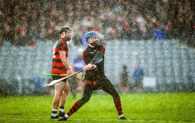 stephen-okeeffe-clears-the-ball-during-a-downpour