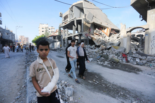 palestinians-walk-by-buildings-destroyed-in-the-israeli-bombardment-of-the-gaza-strip-in-rafah-tuesday-nov-7-2023-ap-photohatem-ali