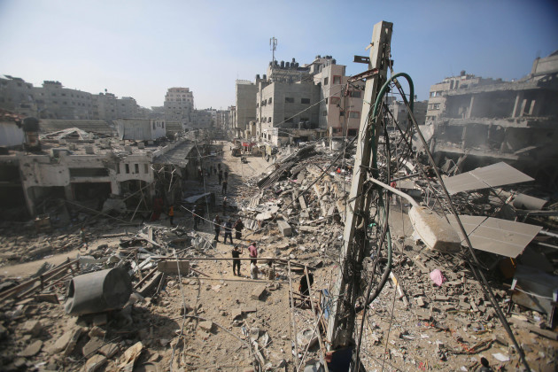 people-search-through-buildings-destroyed-during-israeli-air-raids-on-al-shati-refugee-camp-in-gaza-city-people-search-through-buildings-destroyed-during-israeli-air-raids-on-al-shati-refugee-camp-i