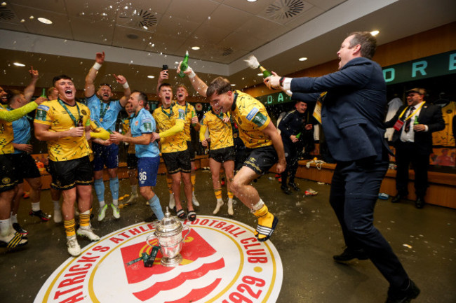 jon-daly-celebrates-in-the-dressing-room-with-his-team