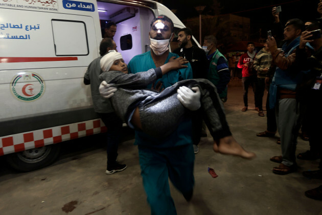 a-wounded-palestinian-boy-is-carried-into-the-nasser-hospital-following-israeli-bombardment-on-khan-younis-refugee-camp-southern-gaza-strip-monday-nov-20-2023-ap-photomohammed-dahman