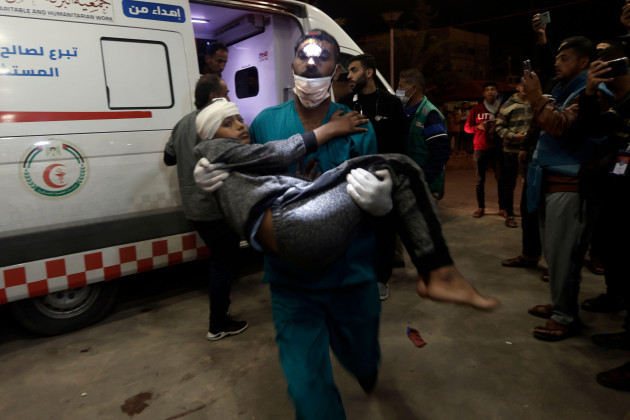 a-wounded-palestinian-boy-is-carried-into-the-nasser-hospital-following-israeli-bombardment-on-khan-younis-refugee-camp-southern-gaza-strip-monday-nov-20-2023-ap-photomohammed-dahman