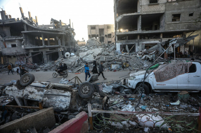 gaza-gaza-30th-nov-2023-palestinians-walk-past-a-destroyed-building-of-israeli-bombing-in-rafah-in-the-southern-gaza-strip-on-thursday-october-30-2023-amid-a-truce-in-fighting-between-israel-an