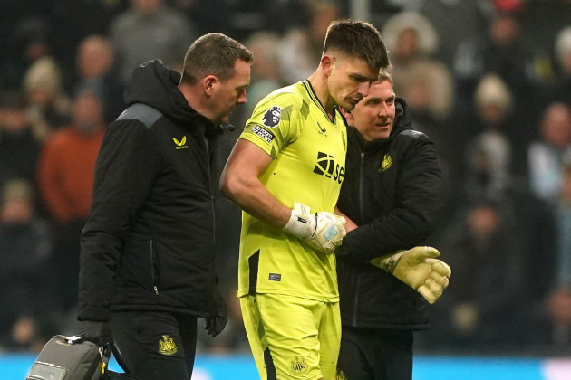 newcastle-united-goalkeeper-nick-pope-centre-is-helped-off-the-pitch-by-medical-staff-after-picking-up-an-injury-during-the-premier-league-match-at-st-james-park-newcastle-picture-date-saturday
